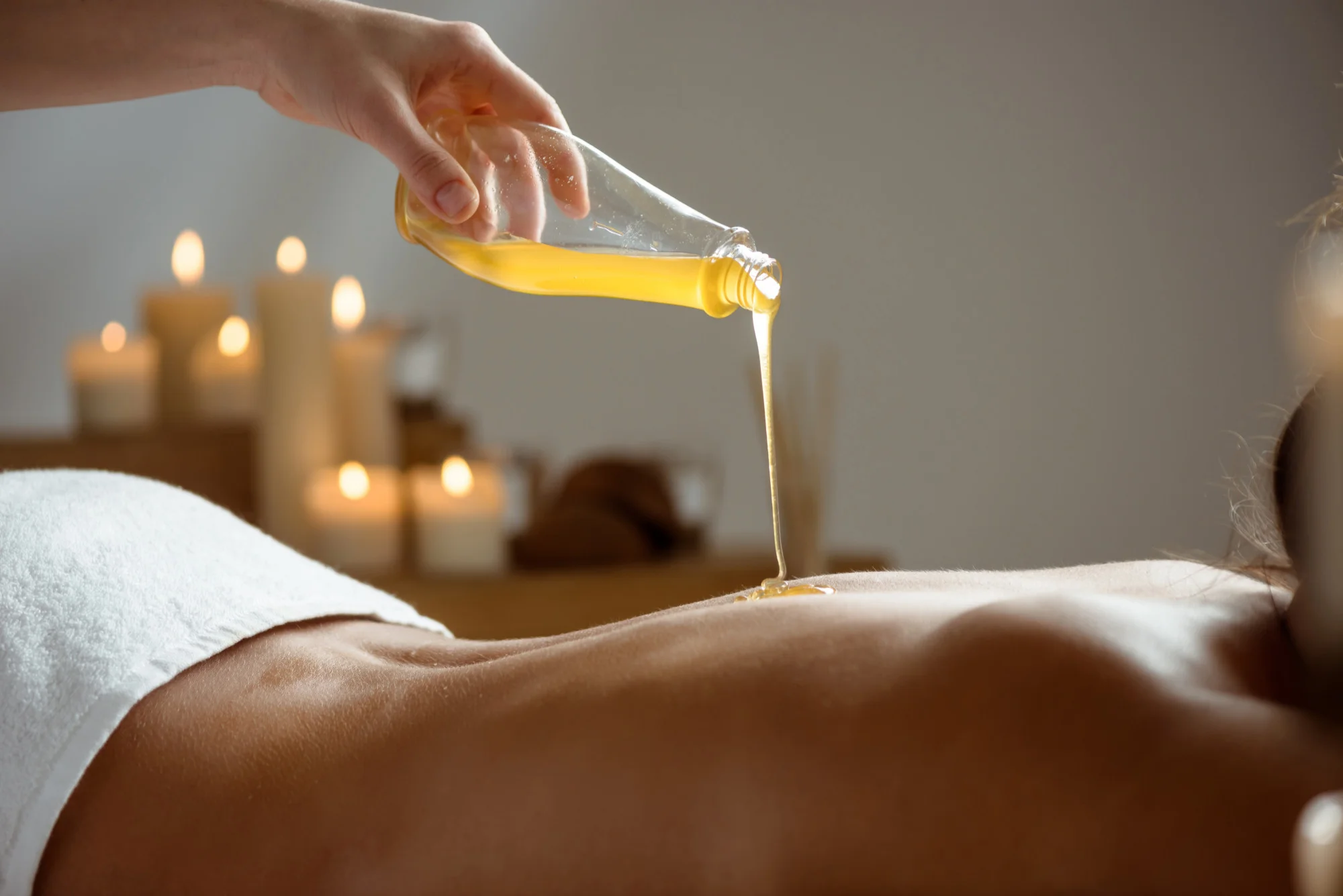 Warm spa treatment oil being applied during massage